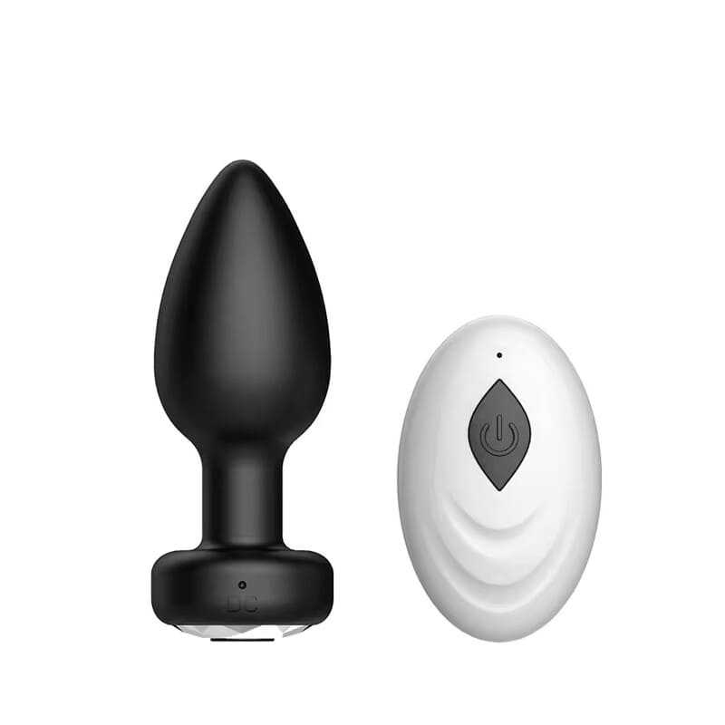 Plug anal negro vibrador con control remoto blanco.